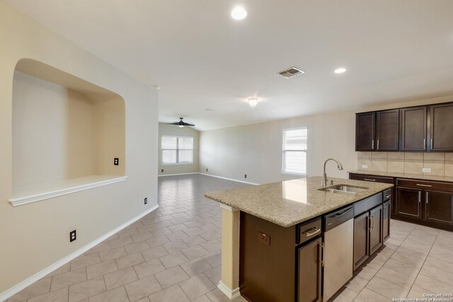 173 Kildeer Crk, San Antonio, TX 78253 - kitchen with stainless steel dishwasher, a sink, dark brown cabinets, a ceiling fan, and light stone countertops