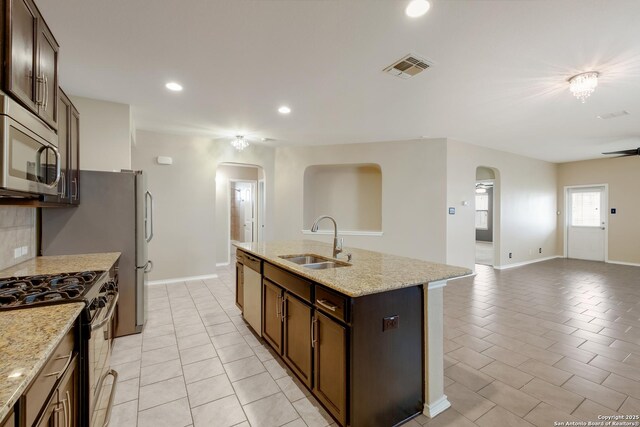 173 Kildeer Crk, San Antonio, TX 78253 - kitchen featuring arched walkways, a sink, appliances with stainless steel finishes, open floor plan, and recessed lighting