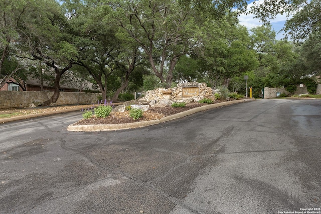 1326 Walkers Way, San Antonio, TX 78216 - view of asphalt road featuring curbs and view of wooded area