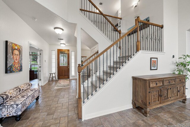 1326 Walkers Way, San Antonio, TX 78216 - entrance foyer featuring stone tile floors, baseboards, stairs, and a towering ceiling