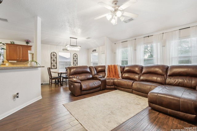 7938 Sterling Mnr, Converse, TX 78109 - living room featuring dark wood-style floors, ceiling fan, and baseboards