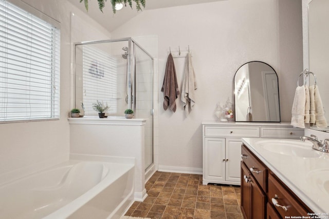 7938 Sterling Mnr, Converse, TX 78109 - bathroom featuring a shower stall, a garden tub, double vanity, baseboards, and stone finish floors