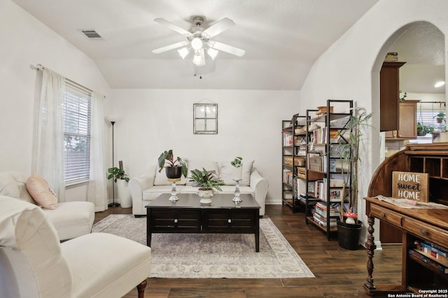 7938 Sterling Mnr, Converse, TX 78109 - living room with vaulted ceiling, ceiling fan, arched walkways, wood finished floors, and baseboards