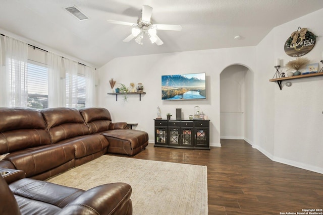 7938 Sterling Mnr, Converse, TX 78109 - living room with arched walkways, a ceiling fan, vaulted ceiling, dark wood-type flooring, and baseboards