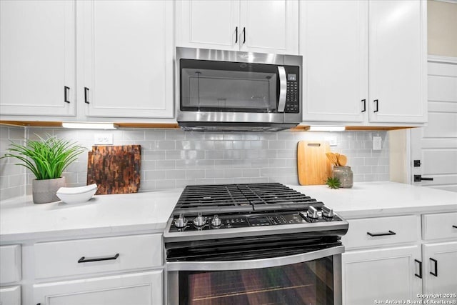 11334 Hill Top Bnd, Helotes, TX 78023 - kitchen with stainless steel appliances, white cabinets, decorative backsplash, and light stone counters