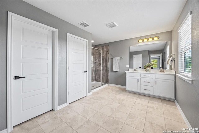 11334 Hill Top Bnd, Helotes, TX 78023 - full bathroom with a shower stall, double vanity, and baseboards