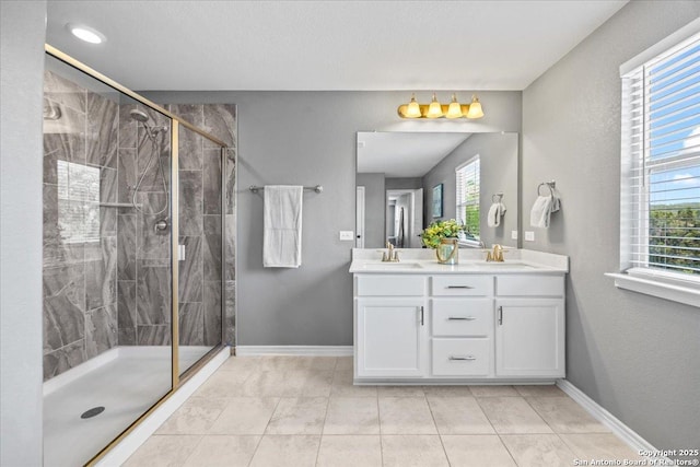11334 Hill Top Bnd, Helotes, TX 78023 - bathroom featuring double vanity, a shower stall, baseboards, and tile patterned flooring