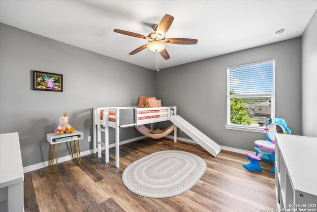 11334 Hill Top Bnd, Helotes, TX 78023 - bedroom featuring baseboards, wood finished floors, and a ceiling fan