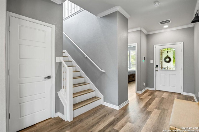 11334 Hill Top Bnd, Helotes, TX 78023 - entrance foyer featuring ornamental molding, stairs, wood finished floors, and baseboards