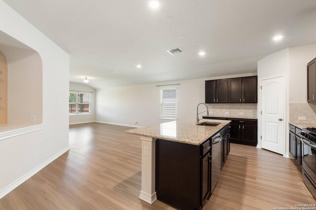 9525 Moon Shine, San Antonio, TX 78254 - kitchen with a sink, light wood-style floors, decorative backsplash, an island with sink, and recessed lighting