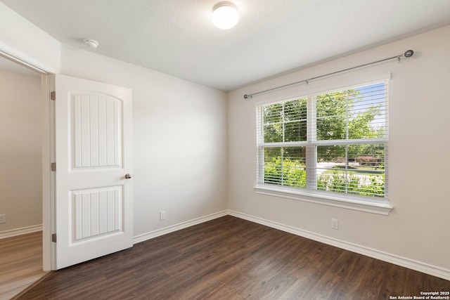 9525 Moon Shine, San Antonio, TX 78254 - empty room with dark wood-style floors, baseboards, and a smoke detector