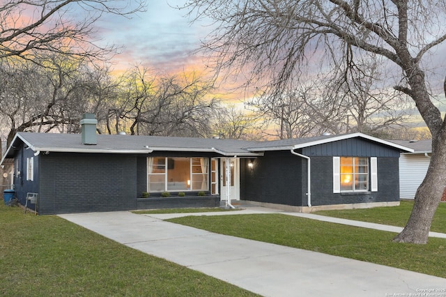 222 Winn, Universal City, TX 78148 - ranch-style home featuring brick siding, a lawn, and a chimney