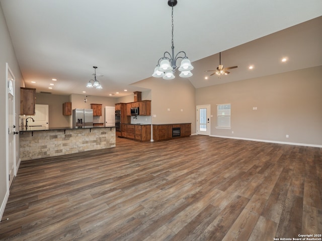 182 Inwood, Poteet, TX 78065 - unfurnished living room featuring a chandelier, recessed lighting, dark wood-style floors, ceiling fan, and a sink