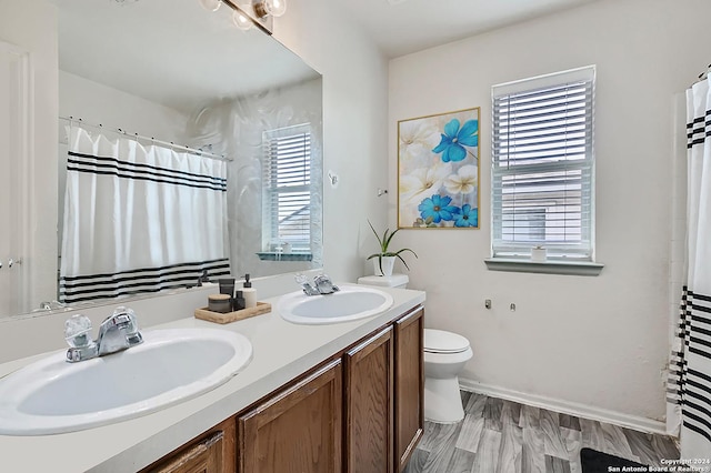 9727 Gypsy Cv, Converse, TX 78109 - bathroom featuring toilet, double vanity, baseboards, and a shower with shower curtain