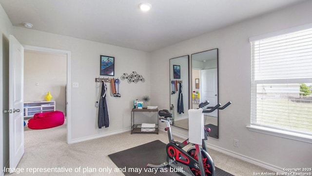exercise room featuring carpet flooring, healthy amount of natural light, and baseboards