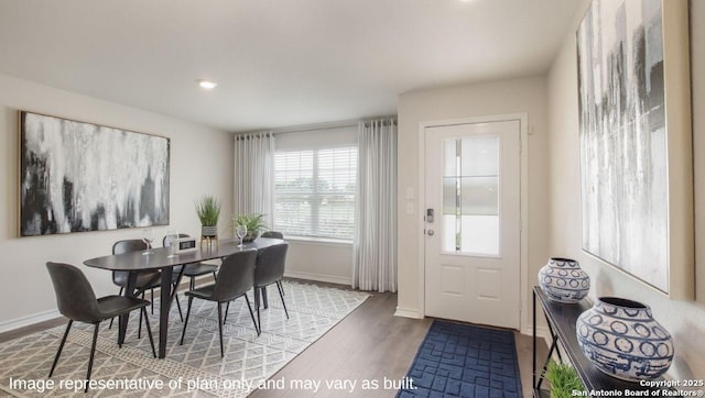 dining space featuring wood finished floors, baseboards, and recessed lighting