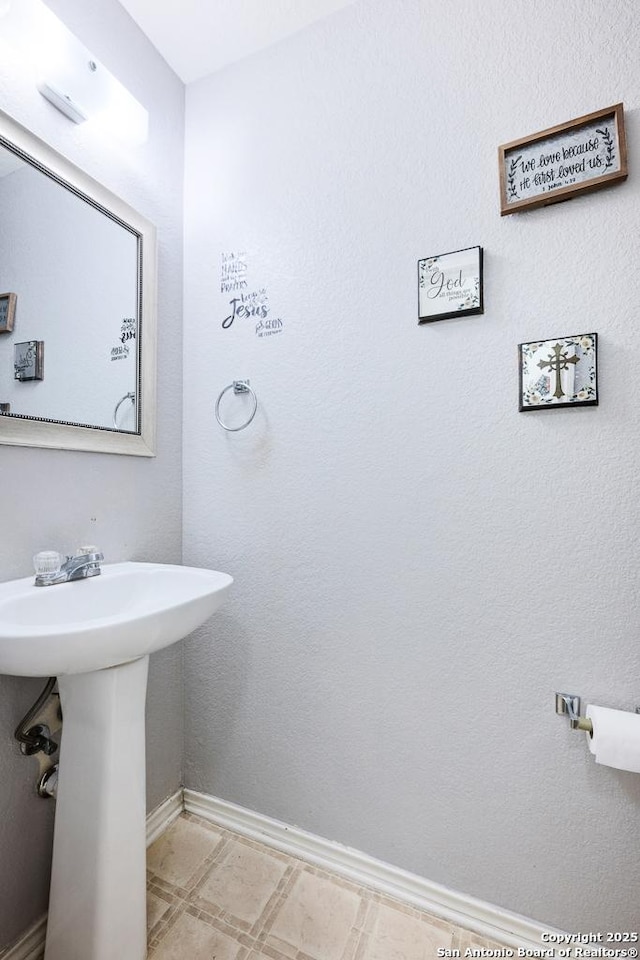 9127 Sycamore, San Antonio, TX 78245 - bathroom with baseboards and a sink