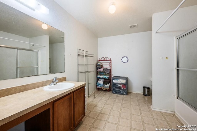 9127 Sycamore, San Antonio, TX 78245 - bathroom with tile patterned floors, an enclosed shower, vanity, and baseboards