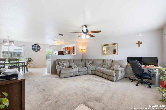 9127 Sycamore, San Antonio, TX 78245 - living area with ceiling fan, light colored carpet, a desk, and baseboards