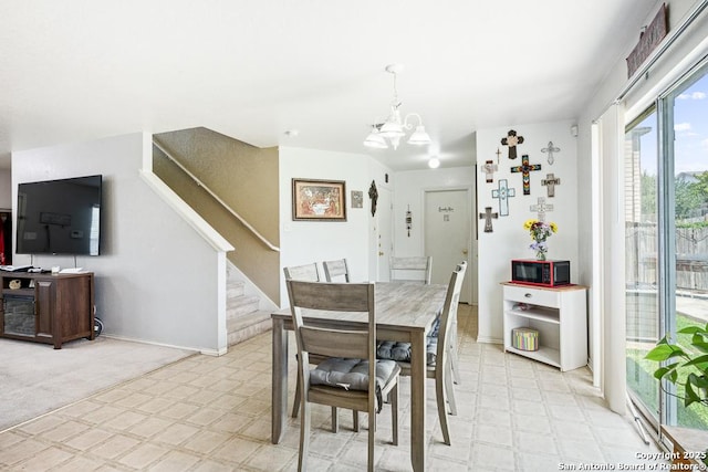 9127 Sycamore, San Antonio, TX 78245 - dining area featuring a chandelier, light floors, stairs, and baseboards