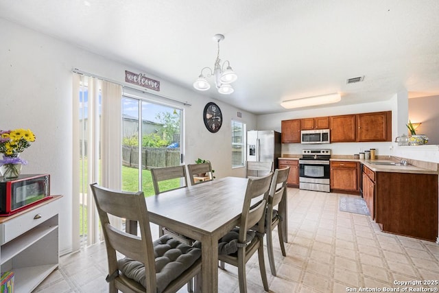 9127 Sycamore, San Antonio, TX 78245 - dining room with a chandelier and light floors