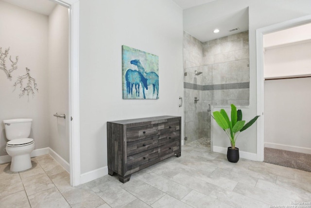 full bath with a stall shower, toilet, baseboards, tile patterned floors, and recessed lighting