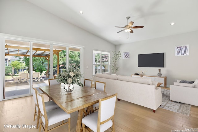 dining space with a ceiling fan, light wood-style flooring, recessed lighting, and high vaulted ceiling