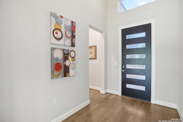entryway featuring wood finished floors and baseboards