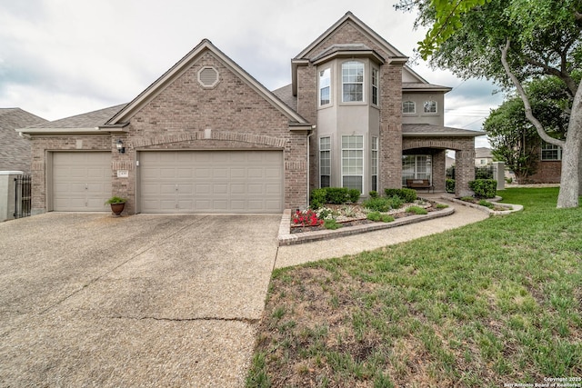 438 Chimney Tops, San Antonio, TX 78260 - traditional-style house with an attached garage, driveway, brick siding, and a front yard