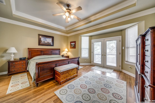 438 Chimney Tops, San Antonio, TX 78260 - bedroom with a tray ceiling, french doors, access to outside, light wood-type flooring, and ornamental molding