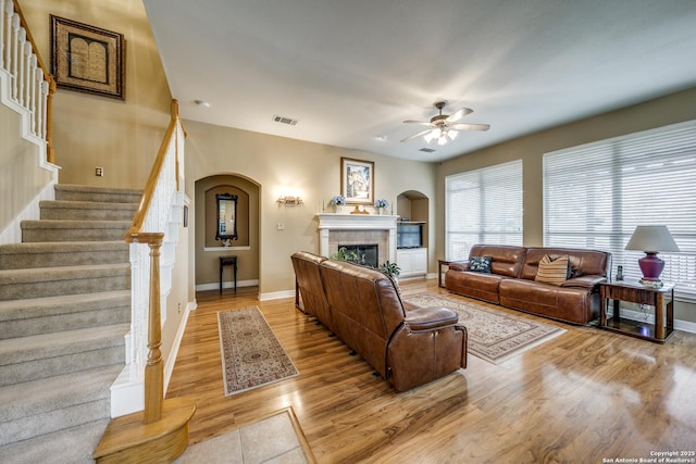 438 Chimney Tops, San Antonio, TX 78260 - living area with ceiling fan, arched walkways, baseboards, stairway, and a tile fireplace