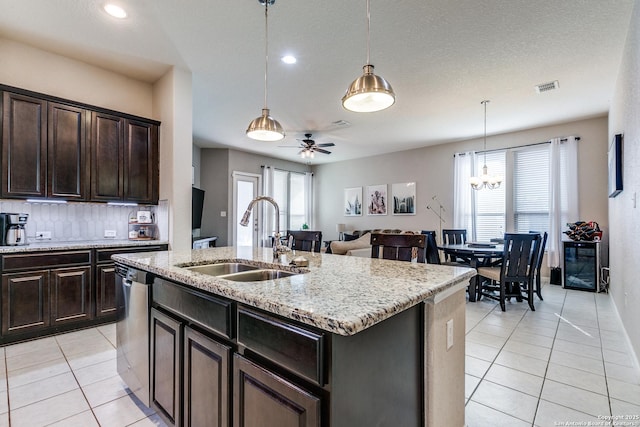 13926 Cohan Way, San Antonio, TX 78253 - kitchen featuring a sink, light tile patterned flooring, stainless steel dishwasher, decorative backsplash, and pendant lighting