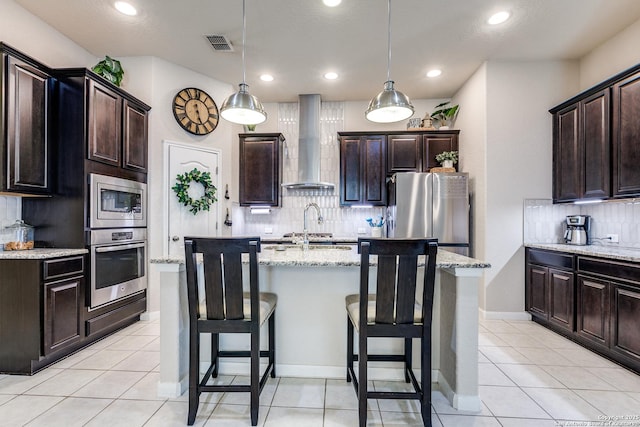 13926 Cohan Way, San Antonio, TX 78253 - kitchen featuring wall chimney exhaust hood, stainless steel appliances, decorative backsplash, an island with sink, and a breakfast bar area