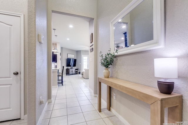 13926 Cohan Way, San Antonio, TX 78253 - hallway with a textured wall, light tile patterned floors, and baseboards