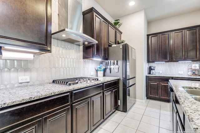 13926 Cohan Way, San Antonio, TX 78253 - kitchen featuring wall chimney exhaust hood, stainless steel appliances, decorative backsplash, light tile patterned floors, and dark brown cabinetry