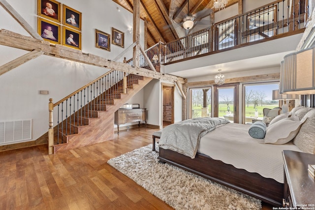 bedroom featuring high vaulted ceiling, wood finished floors, access to outside, beam ceiling, and wood ceiling