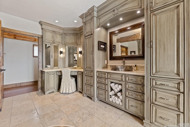 bathroom featuring baseboards, vanity, and stone tile floors