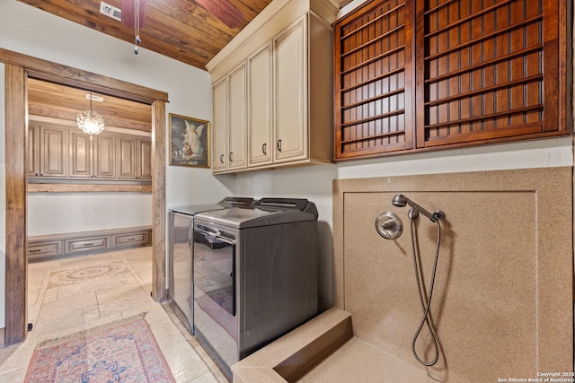 clothes washing area with wooden ceiling and separate washer and dryer