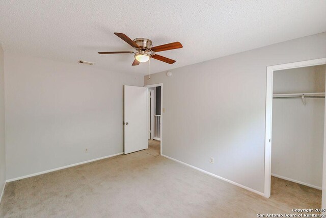 15522 Wood Sorrel, San Antonio, TX 78247 - unfurnished bedroom with a closet, carpet flooring, baseboards, a ceiling fan, and a textured ceiling