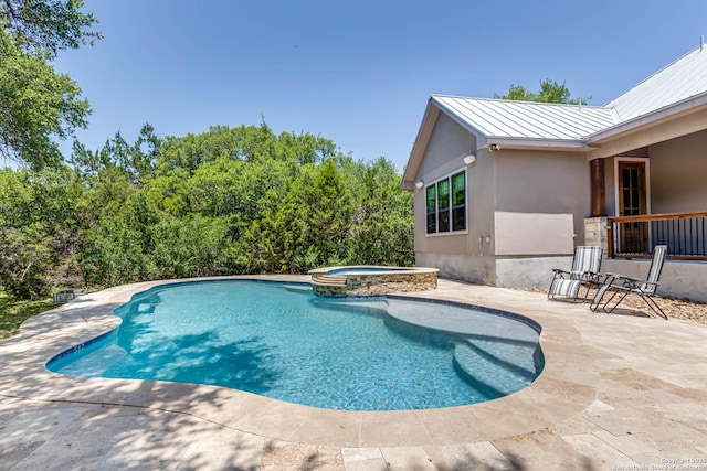 view of swimming pool featuring a patio area and a pool with connected hot tub