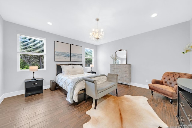 bedroom with a chandelier, wood finished floors, baseboards, and recessed lighting