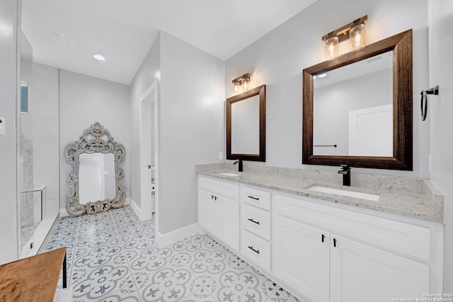 bathroom featuring baseboards, double vanity, and tile patterned flooring