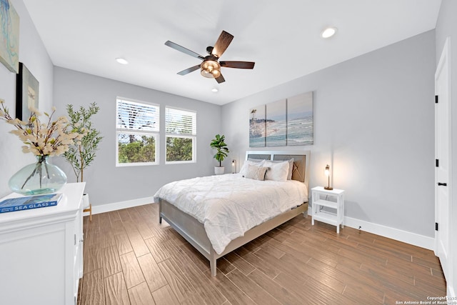 bedroom featuring baseboards, wood finished floors, ceiling fan, and recessed lighting