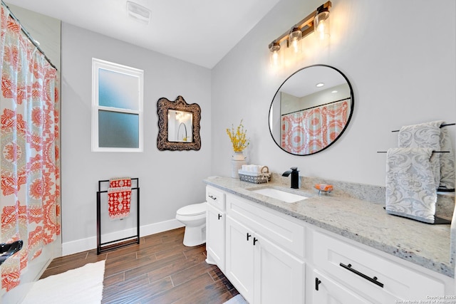 full bathroom featuring wood finished floors, vanity, toilet, baseboards, and a shower with shower curtain