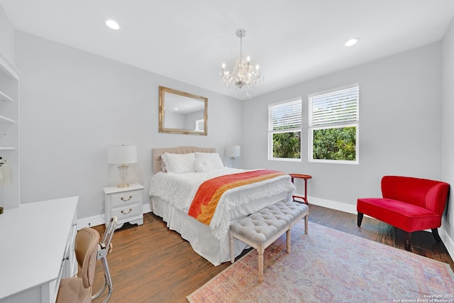 bedroom featuring baseboards, a chandelier, wood finished floors, and recessed lighting