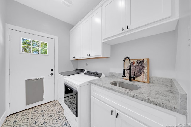 laundry room featuring washing machine and clothes dryer and cabinet space