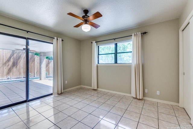 9007 Luzita Ln, San Antonio, TX 78230 - unfurnished room with ceiling fan, light tile patterned floors, and baseboards