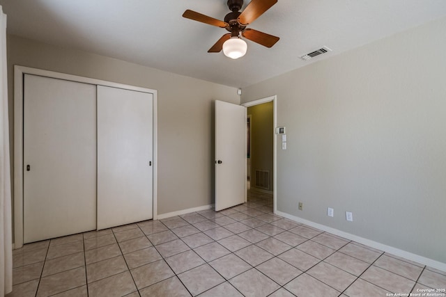 9007 Luzita Ln, San Antonio, TX 78230 - unfurnished bedroom featuring a closet, a ceiling fan, baseboards, and light tile patterned floors