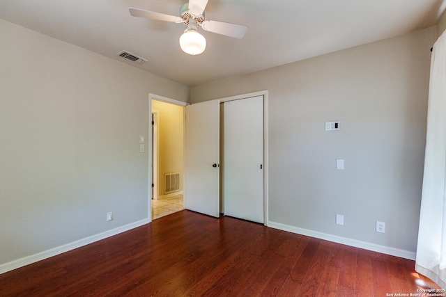 9007 Luzita Ln, San Antonio, TX 78230 - unfurnished bedroom with wood finished floors, baseboards, a closet, and a ceiling fan