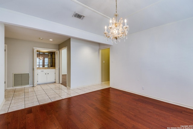 9007 Luzita Ln, San Antonio, TX 78230 - unfurnished room featuring a chandelier, wood finished floors, and baseboards